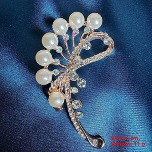 Detail showing elegant rose gold feather brooch with pearls and crystals 6cm length
