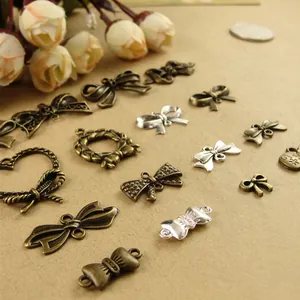Assorted vintage zinc alloy bow charms in bronze and silver finishes for DIY jewelry making