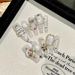 White Christmas press-on nails set with aurora shimmer, 3D snowflakes and star charms