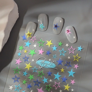 Close-up of colorful star nail stickers applied on translucent tips with deco stones