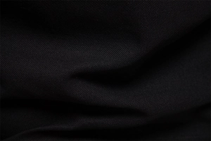 Close-up of high-quality black polo shirt fabric showing breathable woven texture