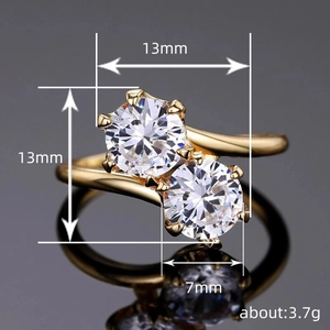 Golden bypass ring with dual round cubic zirconia stones and 13mm face width