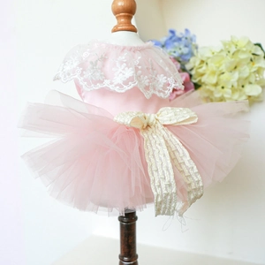 Detailed view of pink pet princess dress with delicate white lace and a beige bow accent