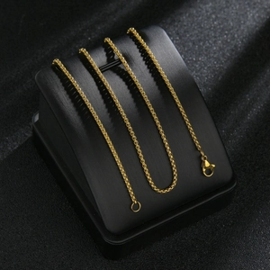 Detailed view of gold stainless steel box chain necklace with lobster clasp closure