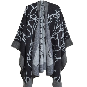 Women's black and grey knitted poncho with botanical jacquard totem pattern for autumn