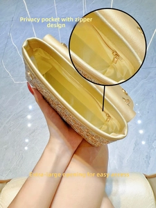 Detail view of gold sequin evening bag interior with zipper pocket and large opening