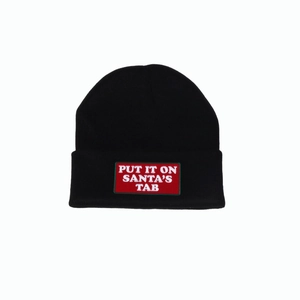 Detail of Santa's Tab embroidered patch on a black winter knitted beanie hat