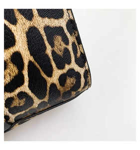 Close-up of the leopard print textured leather and fine stitching of this handbag