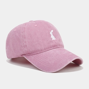 Close-up of white rabbit embroidery on pink washed cotton vintage baseball cap