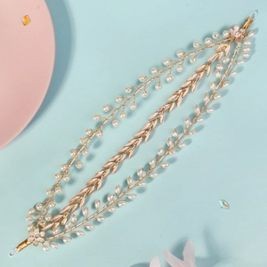 Detail of gold floral headband with white pearls and crystal leaf beaded hair accessory