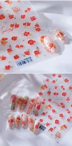 Detail of rose and script nail art stickers featuring elegant floral letter designs