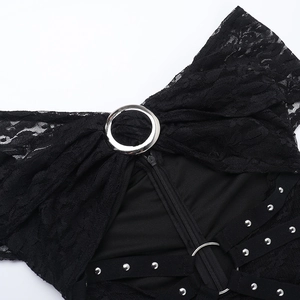 Detail of gothic lace jumpsuit featuring silver metal rings, studs, and zipper closure