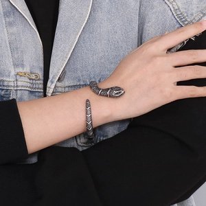 Close-up of vintage stainless steel snake bangle with detailed scales on wrist