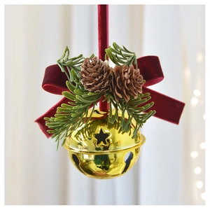 Detail of Christmas bell ornament with velvet bow, pine cones and needles hanging via red ribbon