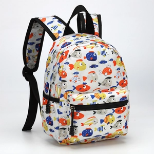Detail view of a 13 inch kids backpack featuring colorful cartoon fish print on white fabric