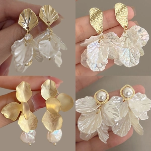 Elegant floral shell earrings with pearls and petals in four stylish jewelry designs