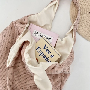 Macro detail of floral corduroy tote bag showing spacious interior and soft fabric texture