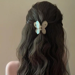 Romantic translucent butterfly hair claw clip with hollow design on a model's hair