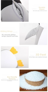 Macro detail of the durable zipper, plush wings and soft foam bead filler of penguin pillow