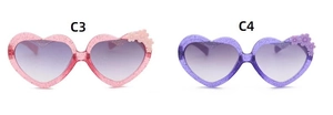 Close-up of glittery pink and purple heart-shaped sunglasses with floral accents
