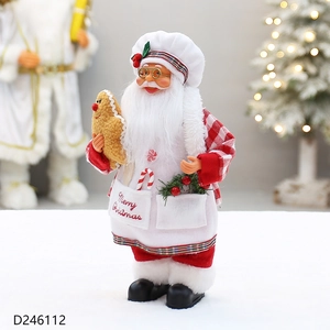 Detail of Christmas chef figurine holding gingerbread man with Merry Christmas embroidery