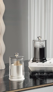 Detail of minimalist acrylic storage jars for cotton swabs and toothpicks with diamond lids