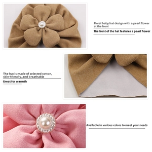 Detailed macro view of soft cotton baby turban with elegant pearl floral ornament