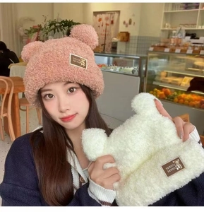 Detail of plush bear ear hat showing soft pink teddy fleece texture and leather label