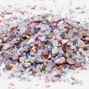 Close-up of mixed colorful irregular glass stones for DIY crafts and nail art decor