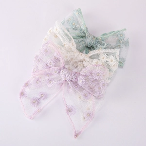 Three-piece embroidered daisy mesh bow hair clips in light green, beige, and purple