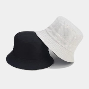 Close-up of corduroy texture on black and white bucket hats with minimalist style