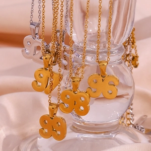 Detail of numeric pendants on clear glass with 18K gold and silver plating on O-chains