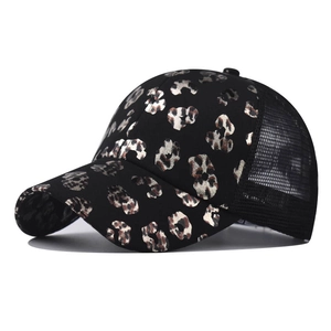 Detail of black leopard print baseball cap featuring gold foil pattern and breathable mesh