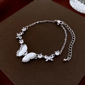 Elegant silver butterfly bracelet featuring white shell texture and sparkling zircon stones