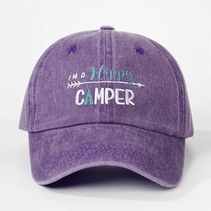 Detailed embroidery of I'M A HAPPY CAMPER text on purple washed denim baseball cap