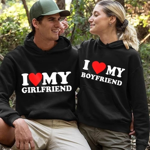 Matching black hoodies with I Love My Boyfriend Girlfriend print in sunny outdoor setting