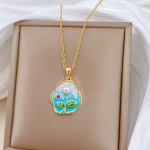 Elegant gold titanium necklace with Monet-inspired enamel pendant and pearls on white silk