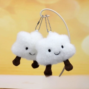 Detail of cute white cloud plush keychain with brown legs and silver metal bead chain