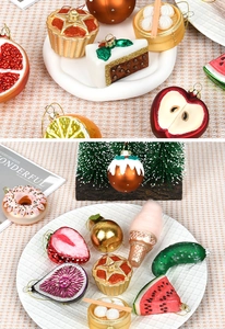 Detailed close-up of glittery glass Christmas ornaments in fruit and food shapes