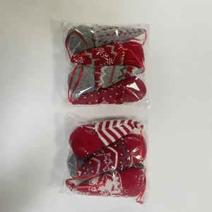 Detail of 4-pack Christmas gnome ornaments in red and white knitted hats packaging