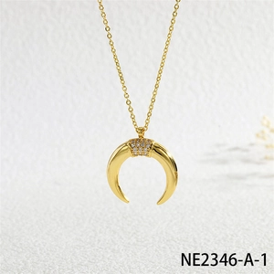 Detailed close-up of golden crescent moon pendant with micro-pave zirconia crystals