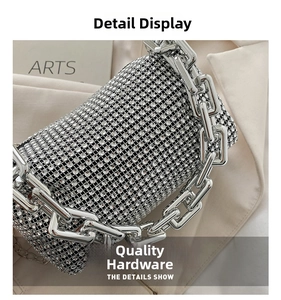 Detail of silver rhinestone evening bag featuring a chunky metallic chain strap