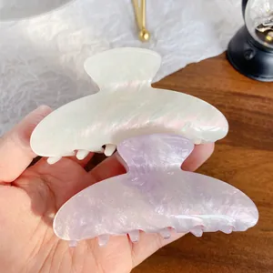 Iridescent acrylic claw clips in pearl white and soft purple with shimmering finish