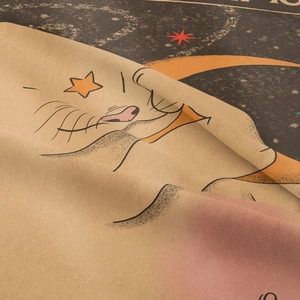 Close-up of bohemian cat tapestry fabric showing detailed beige cotton weave and vintage print