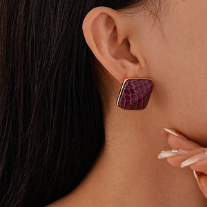 Vintage deep purple faux leather square studs with golden trim on model