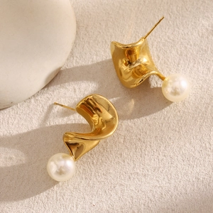 Detailed macro view of 18K gold plated twisted earrings with elegant white pearl accents