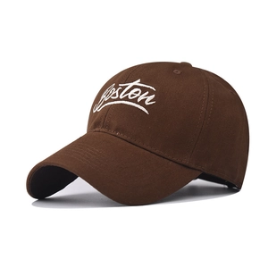 Close-up of Boston embroidery on dark brown cotton baseball cap with white textured stitching