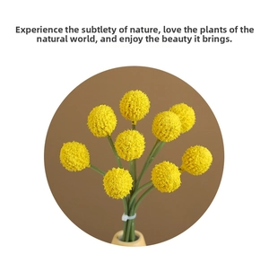 Macro detail of artificial yellow Craspedia globosa flowers in a ceramic vase