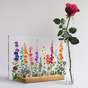 Close-up of a floral acrylic art block with vibrant roses and a solid wooden base