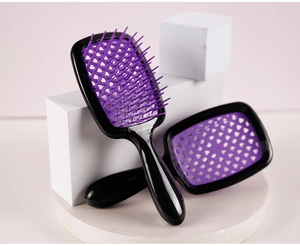 Detail of two black and purple hollow grid hairbrushes for detangling and styling
